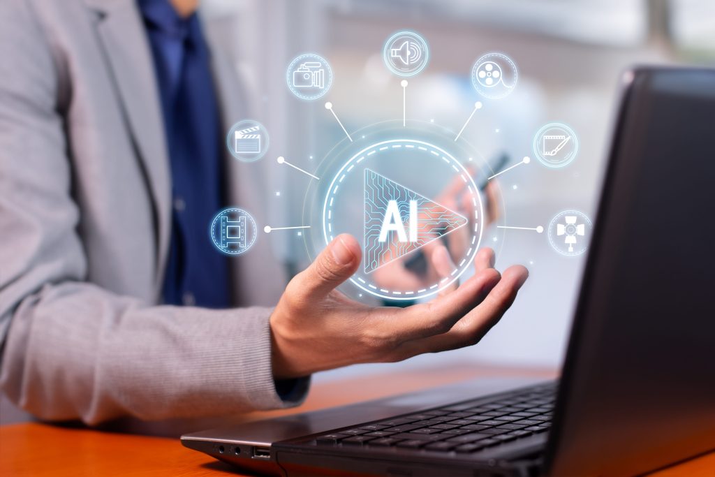 Guy holding AI in front of laptop tool